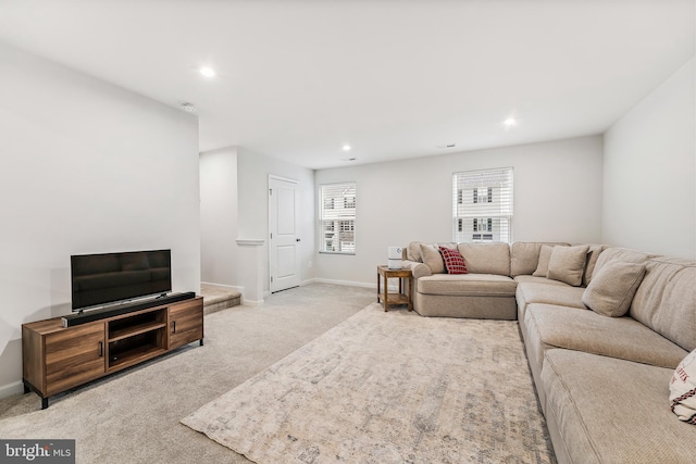 living room featuring a healthy amount of sunlight and light carpet