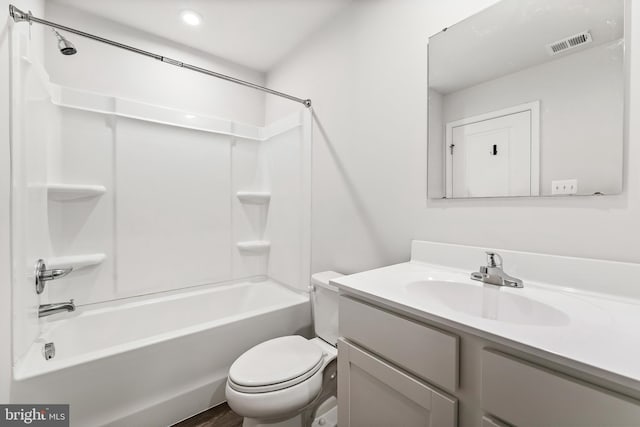 full bathroom featuring washtub / shower combination, vanity, and toilet