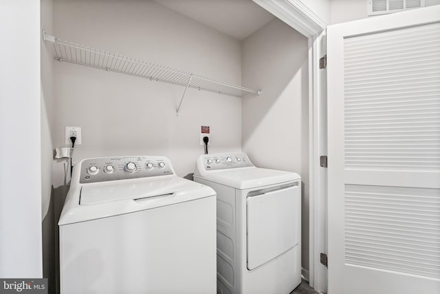 clothes washing area with independent washer and dryer