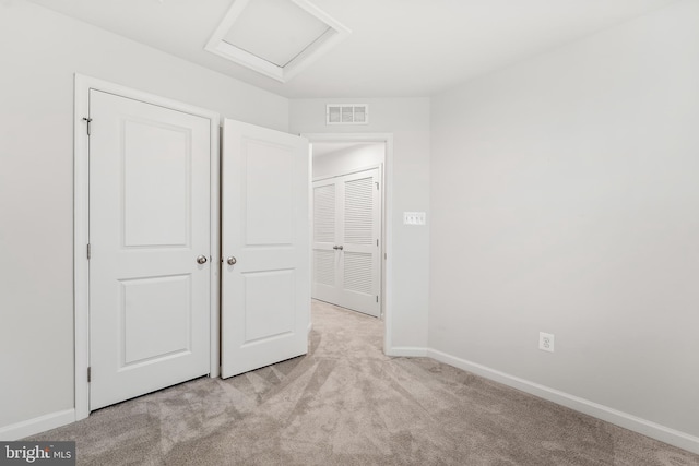 unfurnished bedroom featuring light carpet