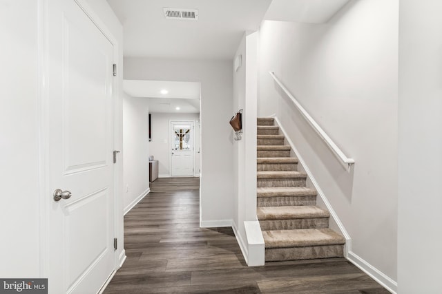 stairway with hardwood / wood-style flooring