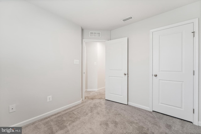 unfurnished bedroom featuring light colored carpet