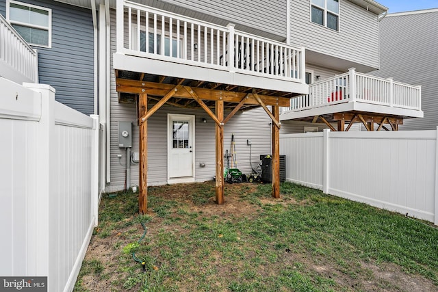 exterior space featuring a wooden deck, a yard, and central AC unit