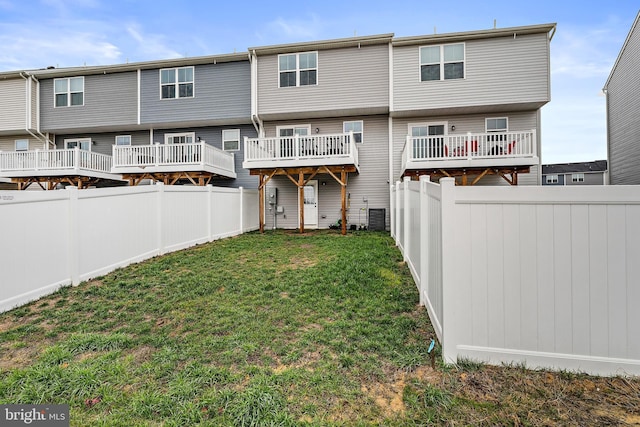 rear view of property with a yard and cooling unit