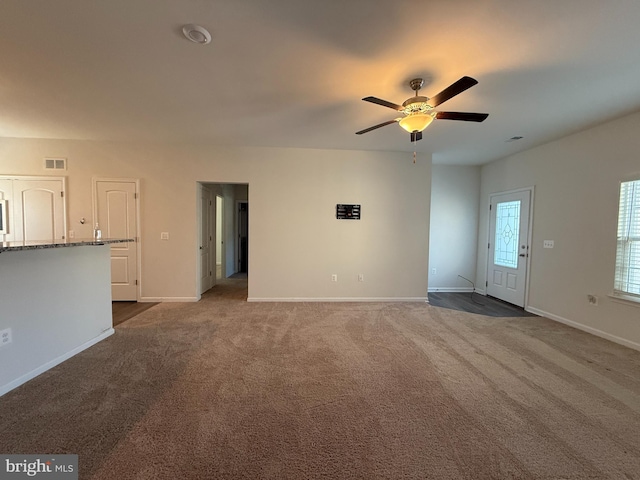 unfurnished living room featuring carpet flooring and ceiling fan