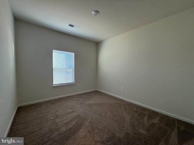 spare room featuring carpet