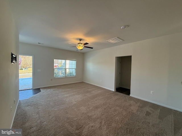 carpeted spare room with ceiling fan