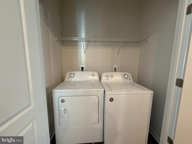 clothes washing area featuring separate washer and dryer