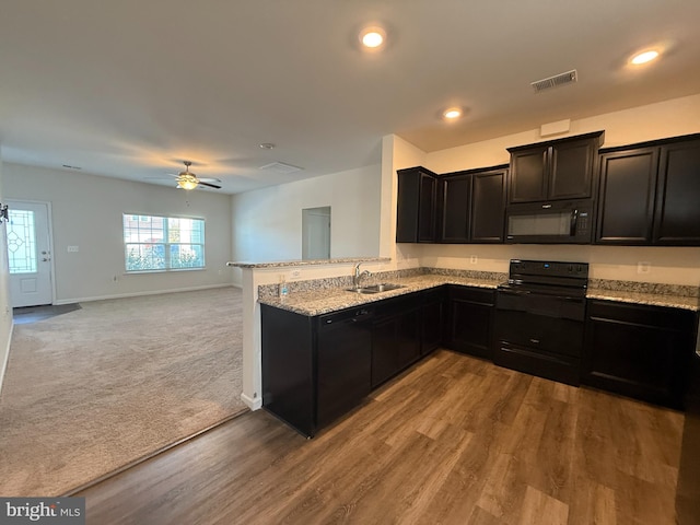 kitchen featuring carpet flooring, ceiling fan, sink, kitchen peninsula, and black appliances