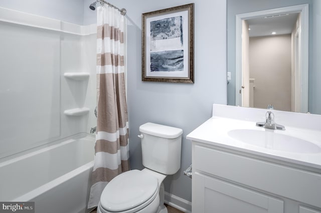 full bathroom featuring shower / tub combo with curtain, vanity, and toilet