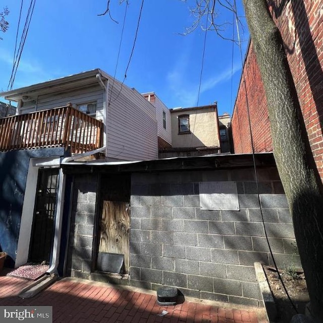 back of property featuring a balcony