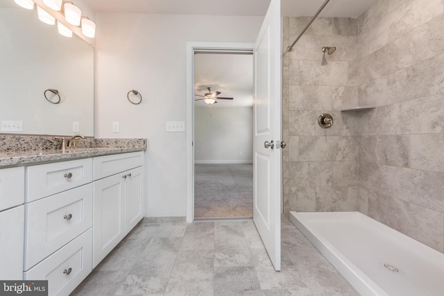 bathroom featuring a tile shower, ceiling fan, and vanity