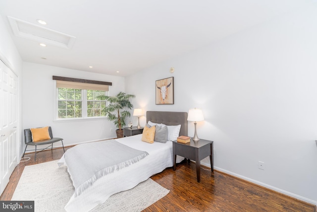 bedroom with dark hardwood / wood-style flooring