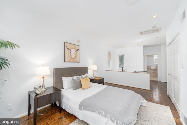 bedroom featuring dark hardwood / wood-style flooring and a closet