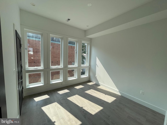 spare room with dark hardwood / wood-style floors