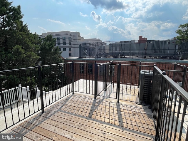 wooden terrace featuring central AC unit