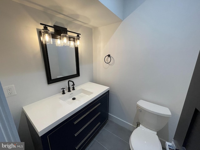 bathroom featuring tile patterned flooring, vanity, and toilet