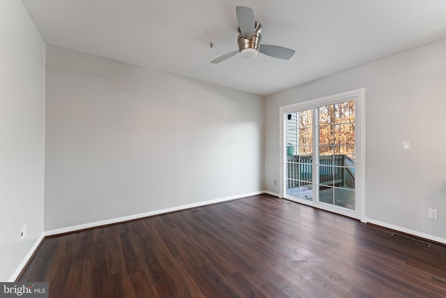 spare room featuring ceiling fan and dark hardwood / wood-style flooring