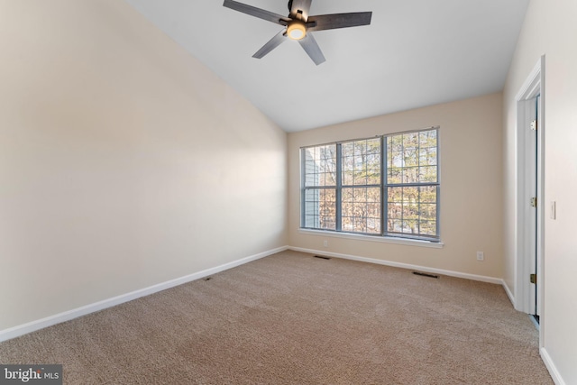 carpeted empty room with ceiling fan and lofted ceiling