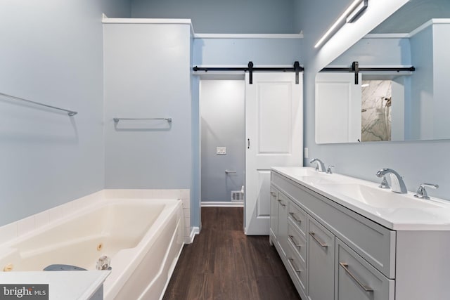 bathroom featuring wood-type flooring, a bathing tub, and vanity