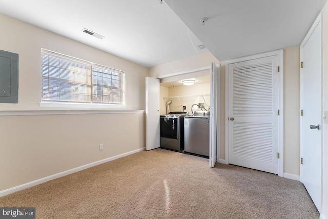 kitchen with separate washer and dryer, light colored carpet, and electric panel