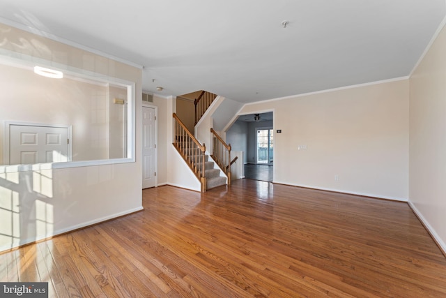 unfurnished room with hardwood / wood-style flooring and crown molding