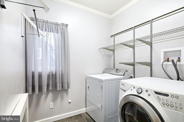 laundry room with crown molding and washer and clothes dryer