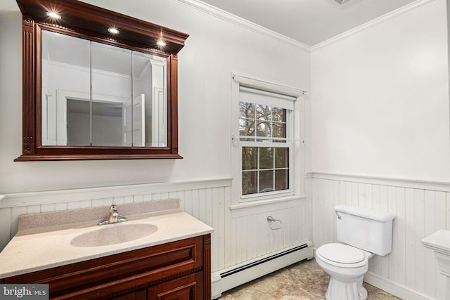 bathroom with crown molding, vanity, a baseboard radiator, and toilet