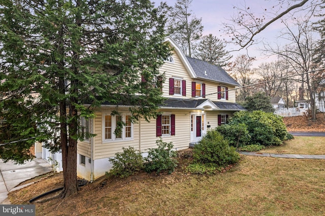 view of front of home featuring a garage and a yard