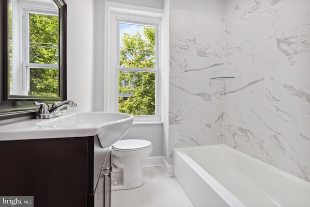 bathroom featuring toilet, vanity, and a wealth of natural light