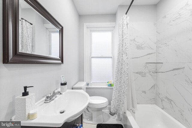 full bathroom with toilet, shower / bath combo, and sink