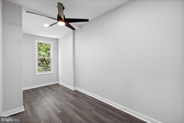 empty room featuring ceiling fan and dark hardwood / wood-style flooring