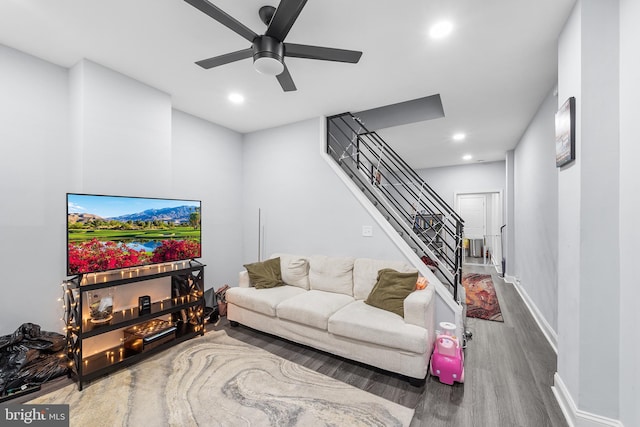 living room with ceiling fan and dark hardwood / wood-style flooring