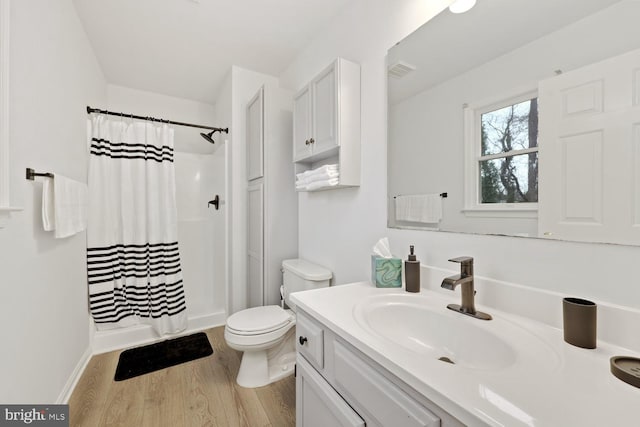 bathroom featuring a shower with curtain, vanity, toilet, and wood-type flooring