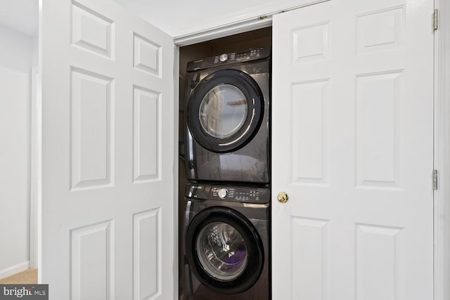 laundry area featuring stacked washer and clothes dryer