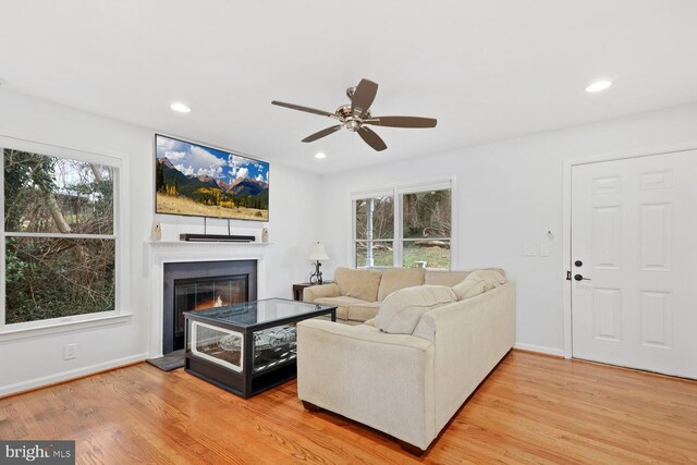 living room featuring hardwood / wood-style floors, ceiling fan, and a healthy amount of sunlight