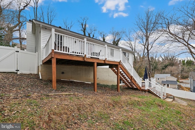 back of house featuring a wooden deck