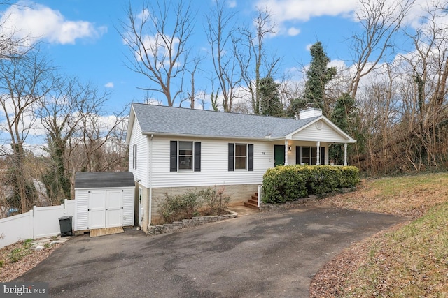 view of front of house featuring a storage unit