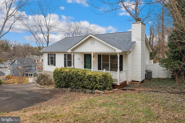 view of front of property featuring a porch and cooling unit