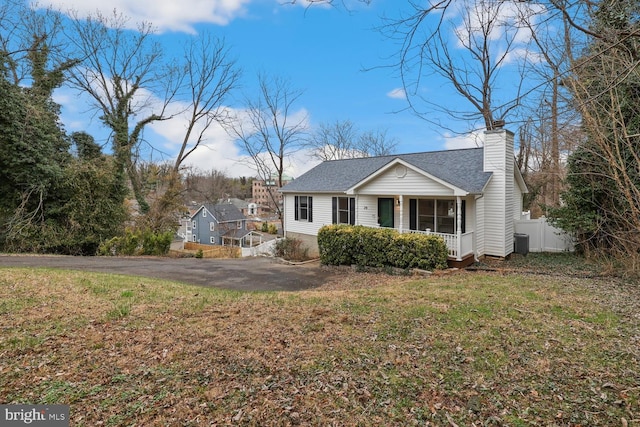 view of front of property with cooling unit and a front lawn