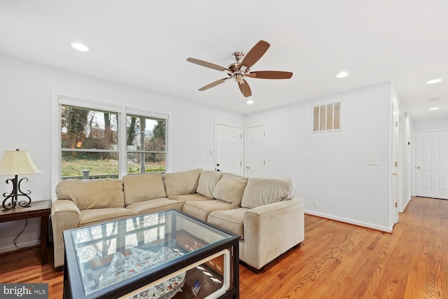 living room with ceiling fan and light wood-type flooring