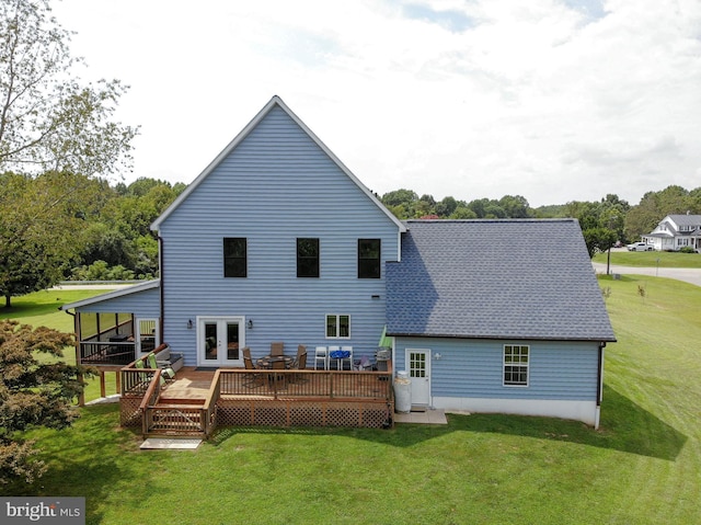 rear view of house with a lawn and a wooden deck