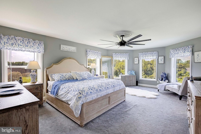 bedroom with multiple windows, carpet, and ceiling fan