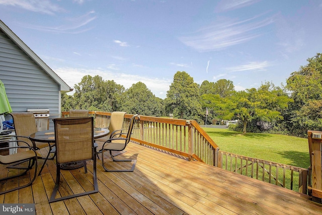 wooden deck with area for grilling and a lawn