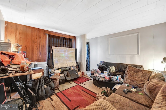 living room with wood walls and light carpet