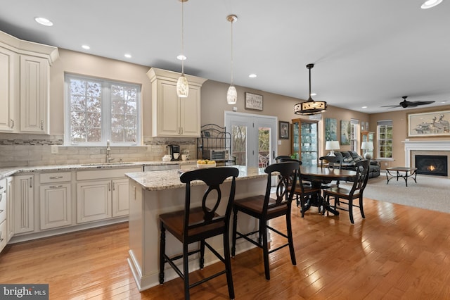 kitchen with plenty of natural light, a kitchen island, and sink