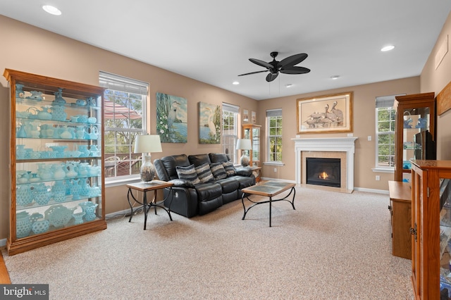 living room with light carpet, ceiling fan, and a healthy amount of sunlight