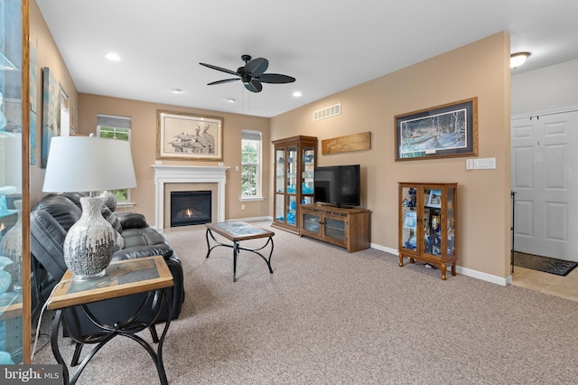 carpeted living room with ceiling fan