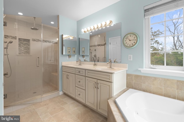 bathroom featuring vanity and shower with separate bathtub