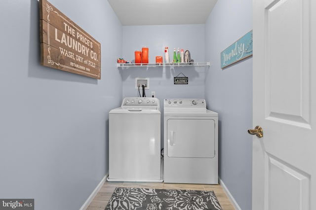 clothes washing area featuring independent washer and dryer and hardwood / wood-style flooring